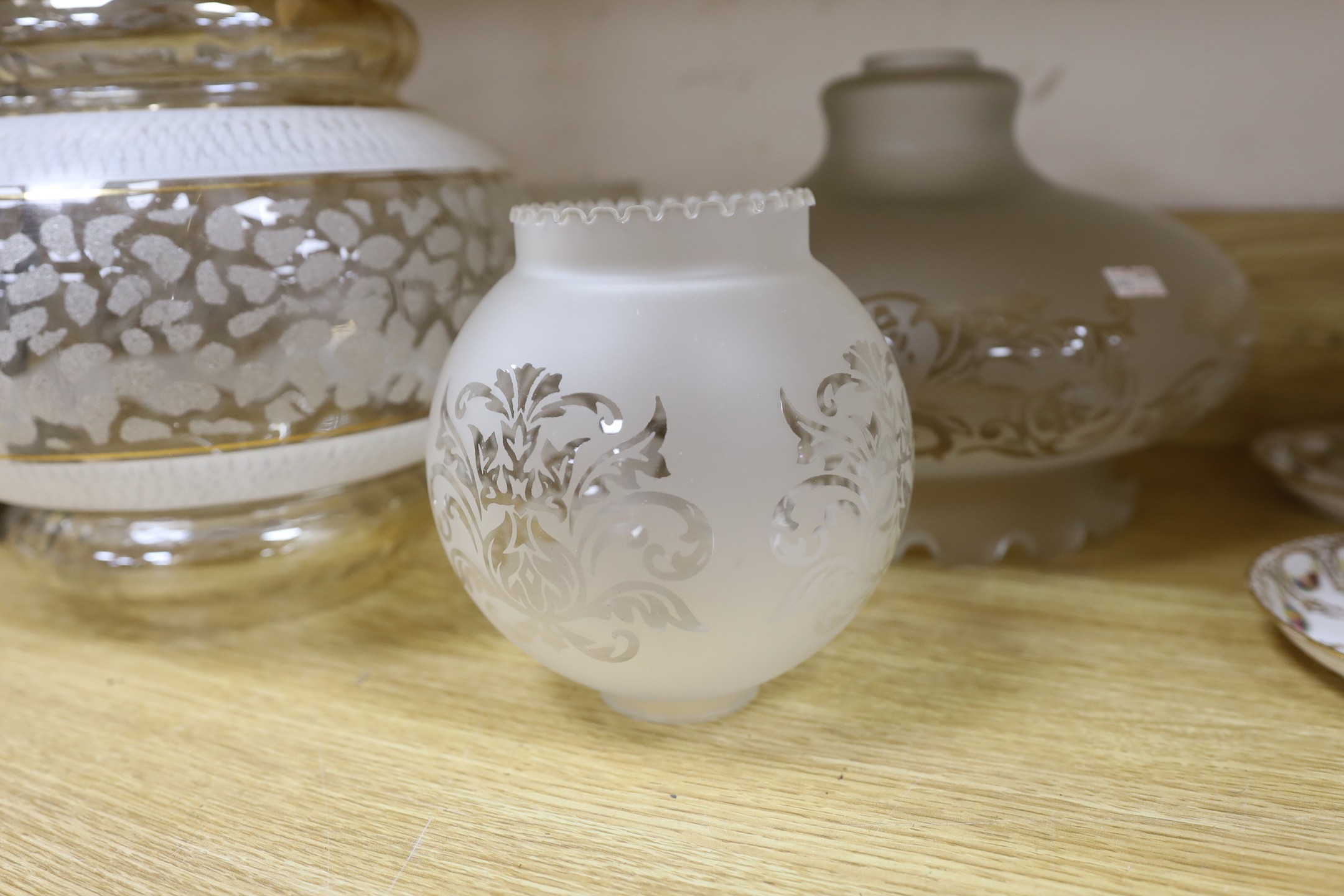 A group of glass lamp shades and an electroplate mounted syphon